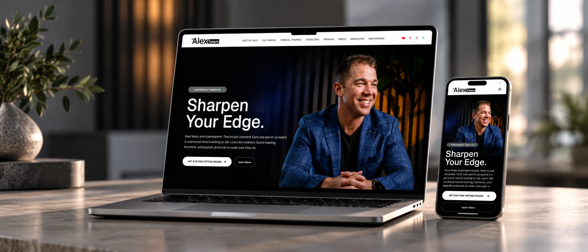 Dr. Alex Tatem website shown on a laptop and a phone